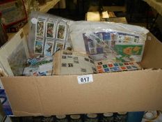 A box of assorted stamps/ cigarette cards etc.,