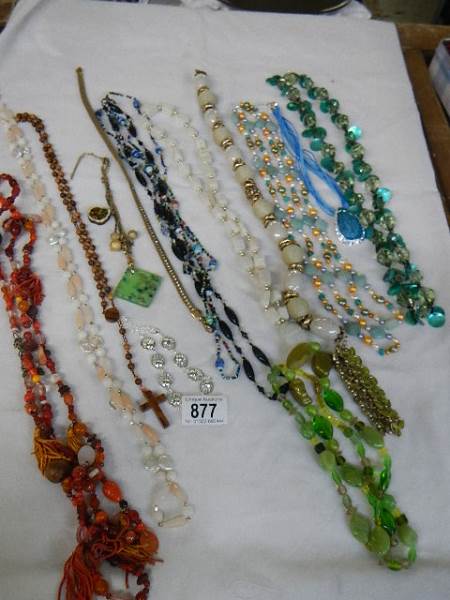 A mixed lot of assorted coloured necklaces.
