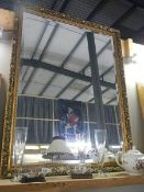 A large gilt framed bevel edged mirror. (Collect only)