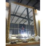 A large gilt framed bevel edged mirror. (Collect only)