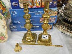 A pair of Victorian brass candlesticks and a candle snuffer.