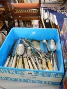 A box of assorted cutlery.