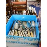 A box of assorted cutlery.