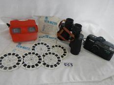 An old viewmaster with 8 discs, a Canon camera and Boot's binoculars.
