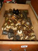 A drawer full of brass and other castors,.