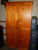 A two door pine wardrobe.