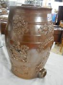 An old brown glazed stoneware barrel.
