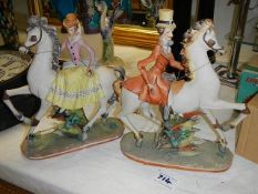 A pair of House of Queensbury figures on horseback.