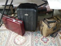 Three items of luggage including briefcase.