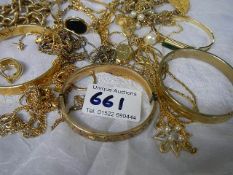 A mixed lot of gold coloured jewellery including bangles.