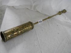 An antique brass hearth brush.