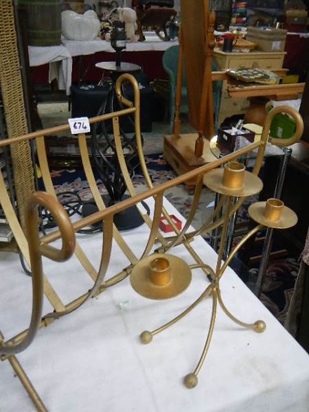 A metal folding magazine rack, a metal lamp and a metal triple candelabra.