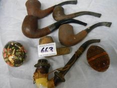 A quantity of old pipes including one with silver collar.