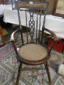A Edwardian elbow chair (missing one spindle).
