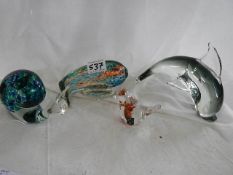 Four unusual glass paperweights.