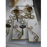 Two pairs of brass wall candleholder and two brass brackets.