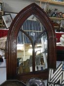 A mahogany arches mirror.