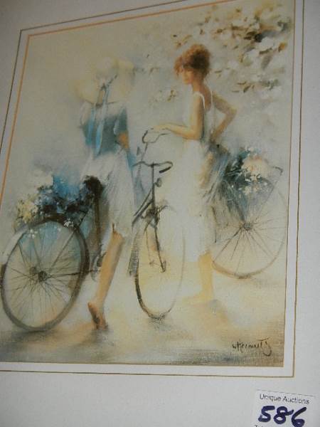 A framed and glazed picture of ladies with bicycles.