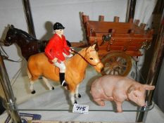 A horse with cart, a hunter on horseback and a pig.