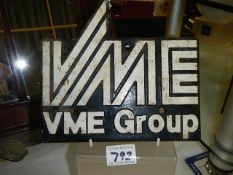 A metal plaque 'VME Group'