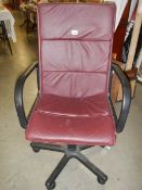 A burgundy office chair in good condition.