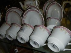 A part teaset and a teapot.