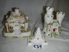 Three pieces of Coalport including cottage and castle.