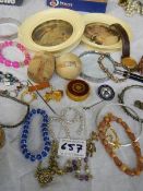 A mixed lot of jewellery, wooden puzzles, pictures etc.,