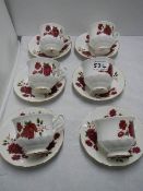 A set of six tea cups and saucers.