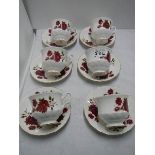 A set of six tea cups and saucers.