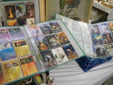 Three folders of fantasy collector's cards.