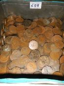 A large tin of old copper pennies.