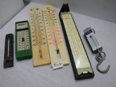 A mixed lot of thermometers, scales and a ruler.
