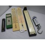 A mixed lot of thermometers, scales and a ruler.