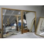 Two gilt framed mirrors.