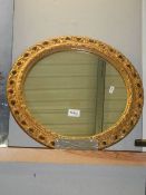 A circular gilt framed mirror.