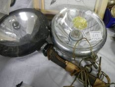 A pair of old car head lamps.