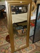 A gilt framed rectangular mirror.