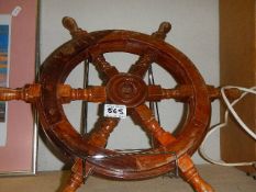 A small wooden ship's wheel.