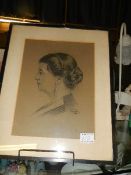 A framed and glazed pencil portrait drawing.