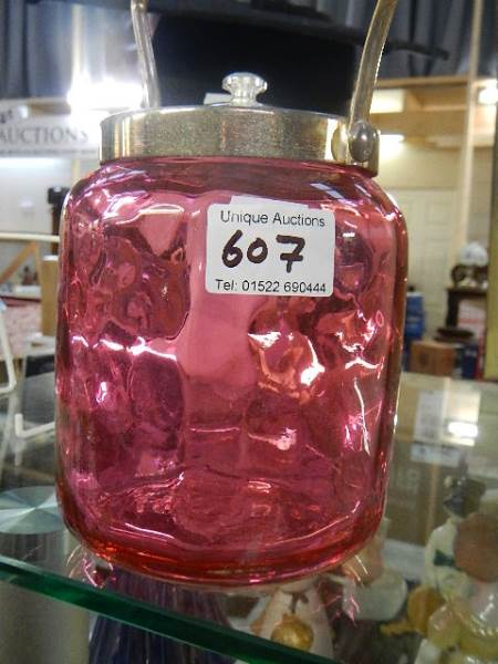 A cranberry glass biscuit barrel.