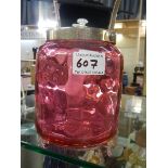 A cranberry glass biscuit barrel.