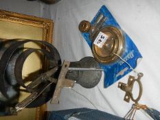 A brass bell and other brassware.