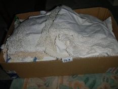 A box of linen including table cloths, napkins, tea towels etc.,
