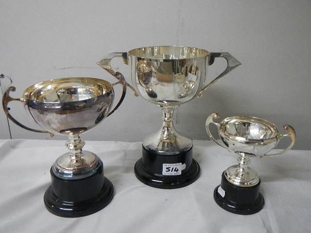 Three silver plate trophies.