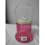 A cranberry glass biscuit barrel with plated fittings.