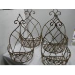 Four metal wall hanging baskets.