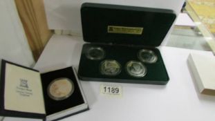 A cased set of four silver proof crowns, Year of the Disabled and an extra Douglas Bader crown,
