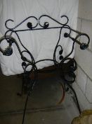 A wrought iron chair style plant stand. COLLECT ONLY.