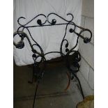 A wrought iron chair style plant stand. COLLECT ONLY.